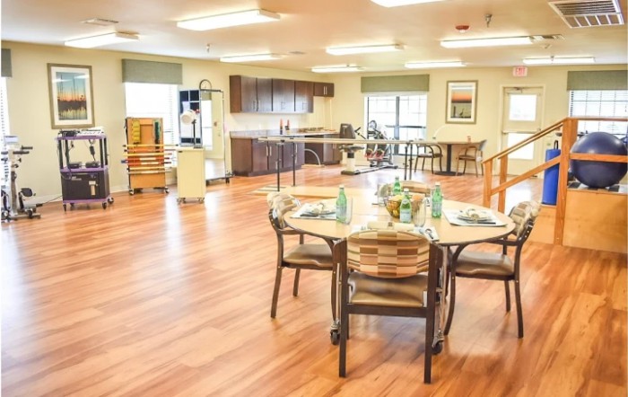 A bright and spacious dining area with a modern kitchen in the background.