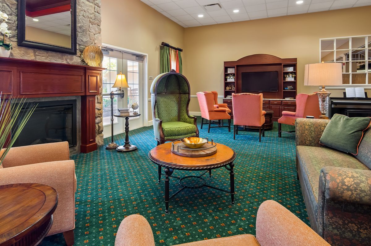 Cozy living room with a fireplace, comfortable seating, and a television.