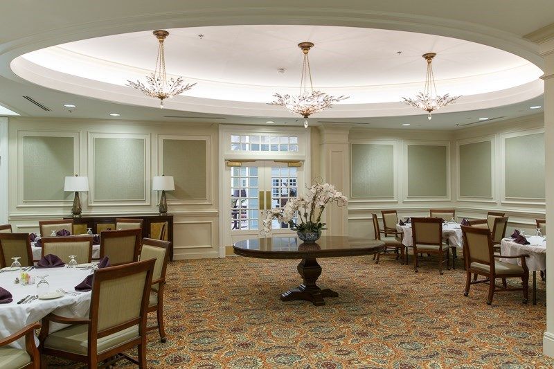 Elegant hotel lobby with chandeliers and finely arranged furniture.