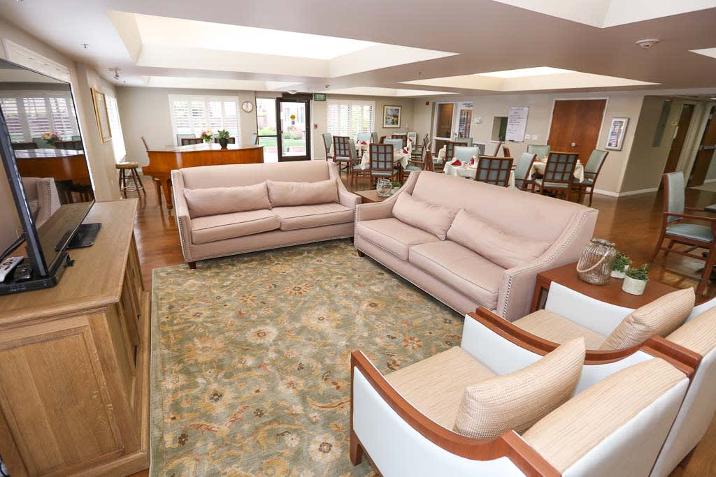 A spacious living room with comfortable seating and elegant decor.
