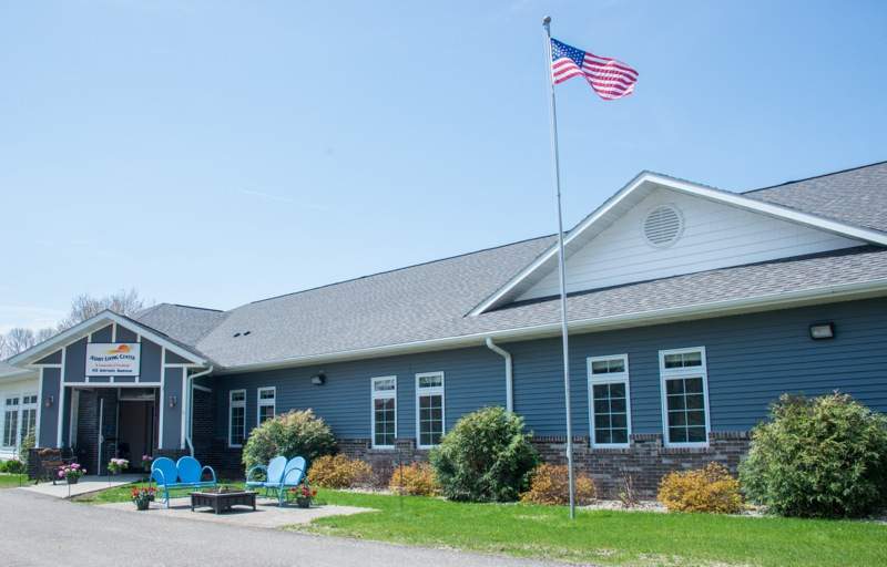 A building with an American flag flying on a sunny day.