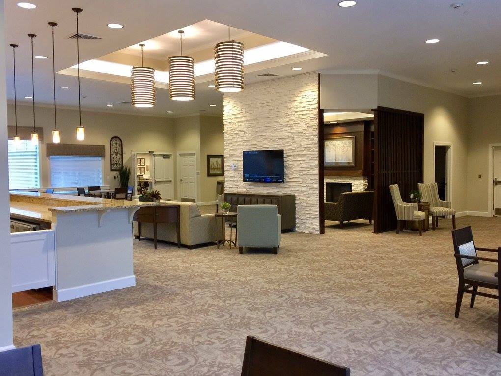 A modern lobby interior featuring comfortable seating and a television.
