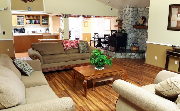 A cozy living room with comfortable seating, a coffee table, and a fireplace.