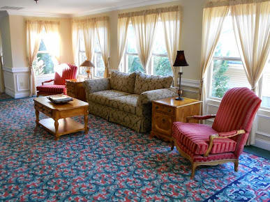 A cozy living room with classic furniture and ample natural light.