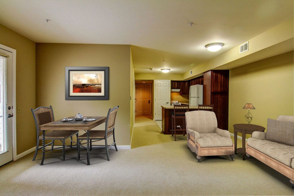 A cozy open floor plan with a dining area and living space, leading into a modern kitchen.