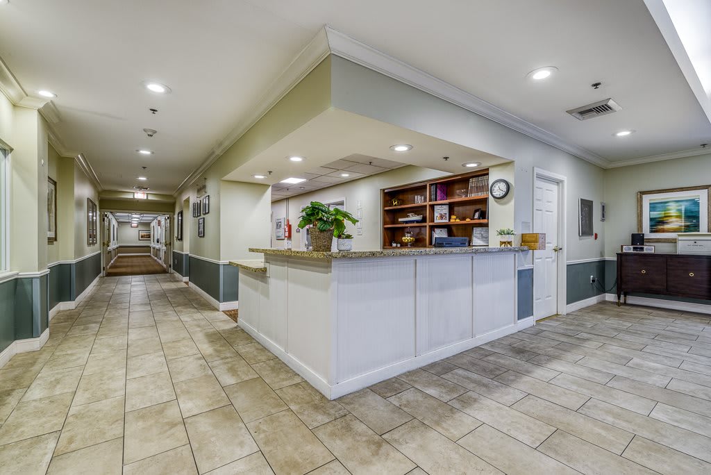 A clean and modern reception area with a spacious desk and organized shelving.