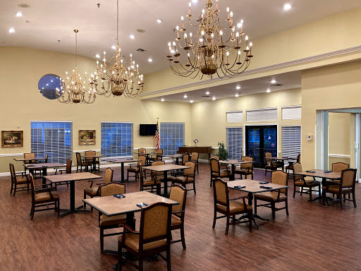 A spacious dining area with elegant chandeliers and a warm ambiance.