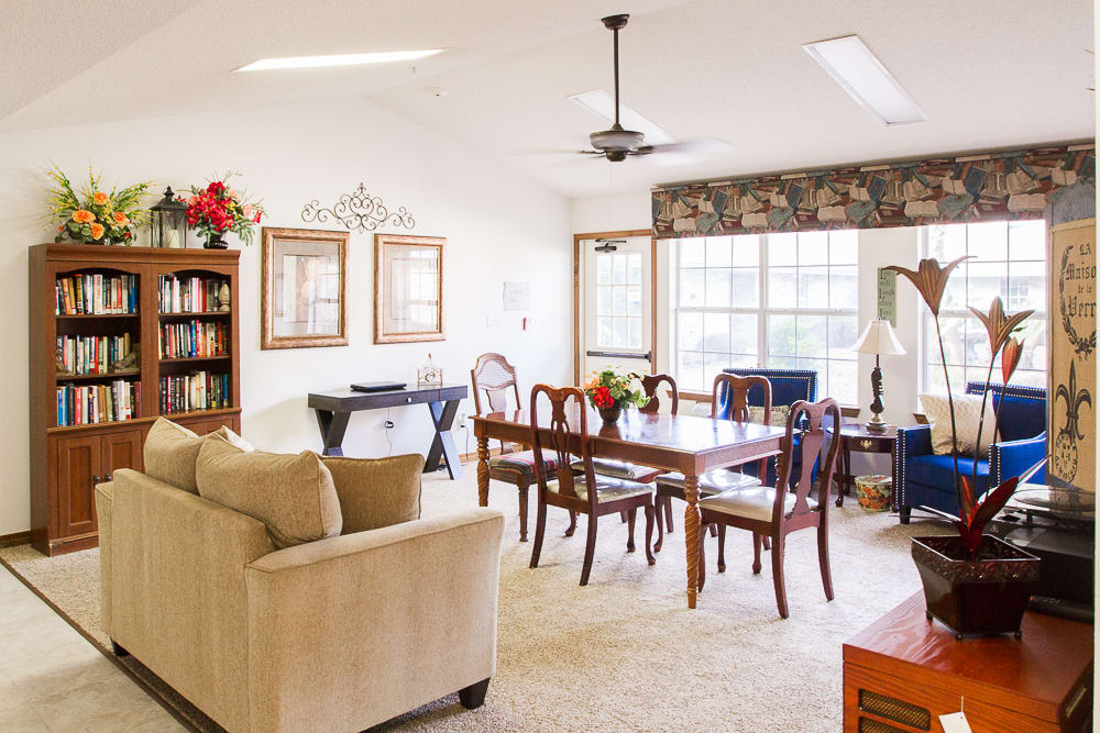 A cozy living room and dining area with elegant furniture and large windows providing ample natural light.