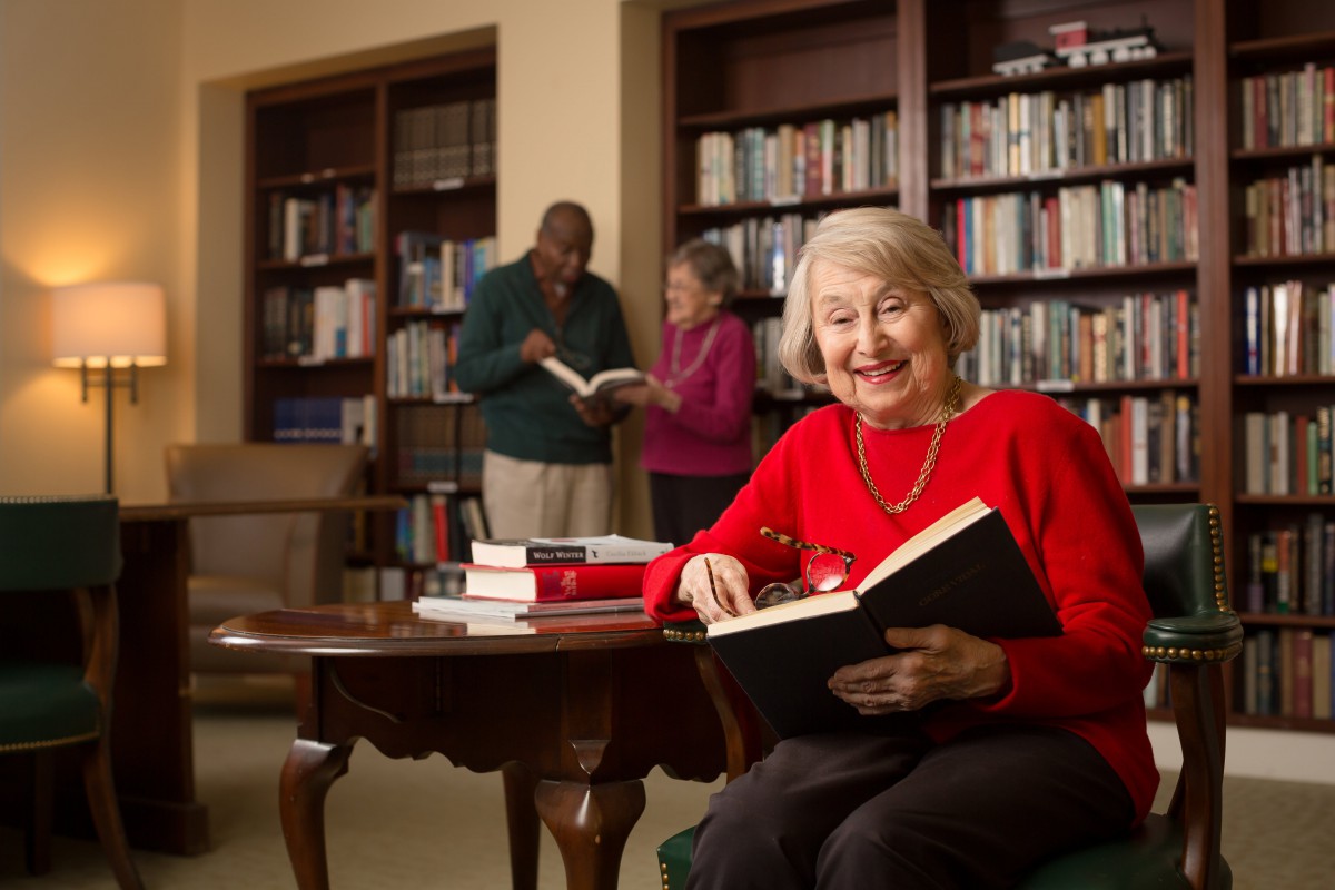A group of people enjoying a quiet reading session in a library.