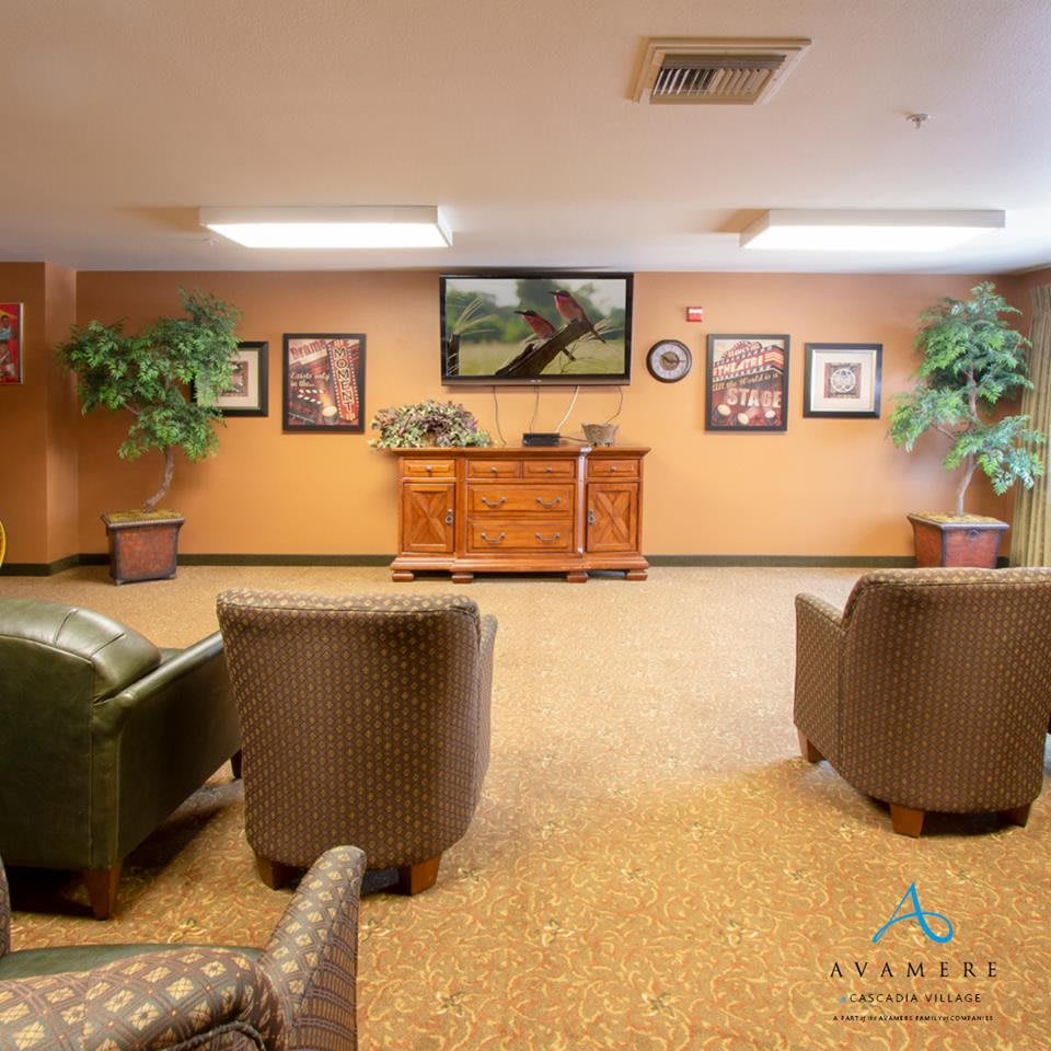 A neatly arranged lobby area with comfortable seating and decorative plants.