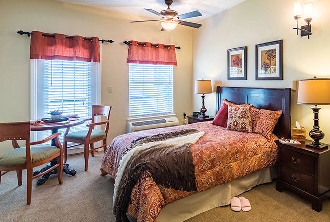 A cozy bedroom with warm decor and natural light.