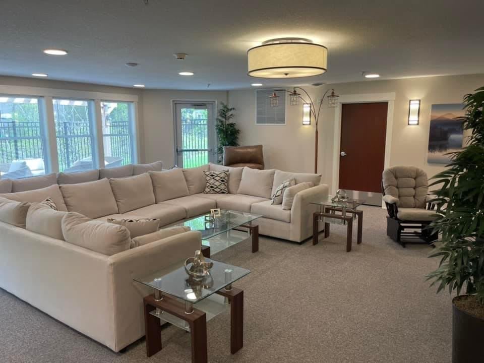 A modern living room with a large sectional sofa and stylish coffee tables.