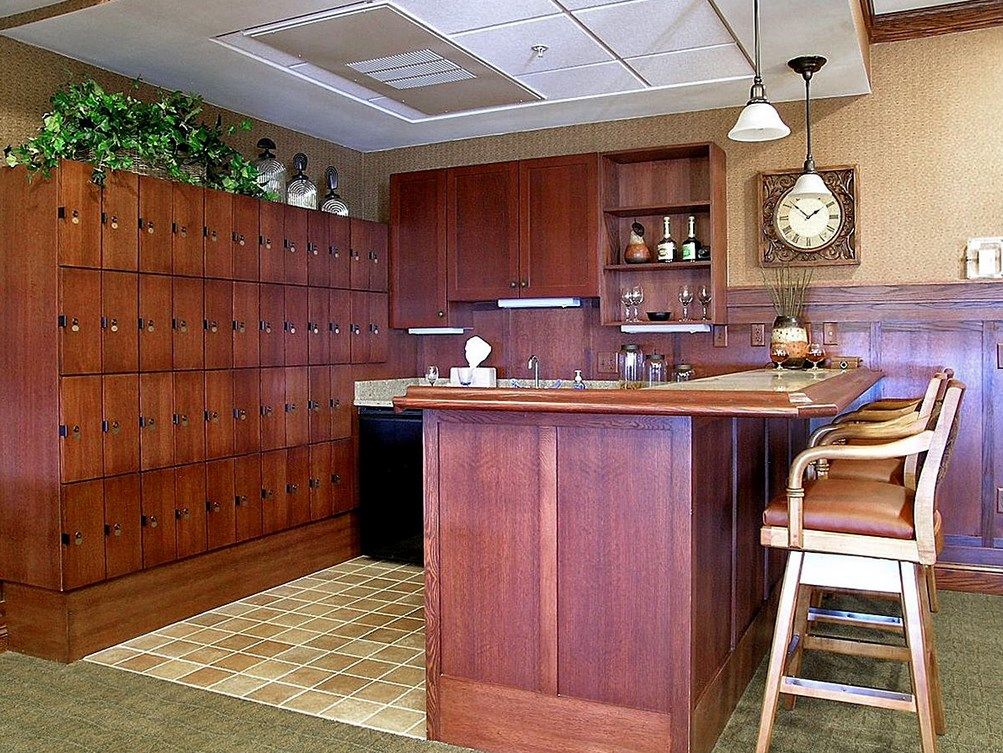 A vintage-style kitchen with wooden cabinets and a bar counter.