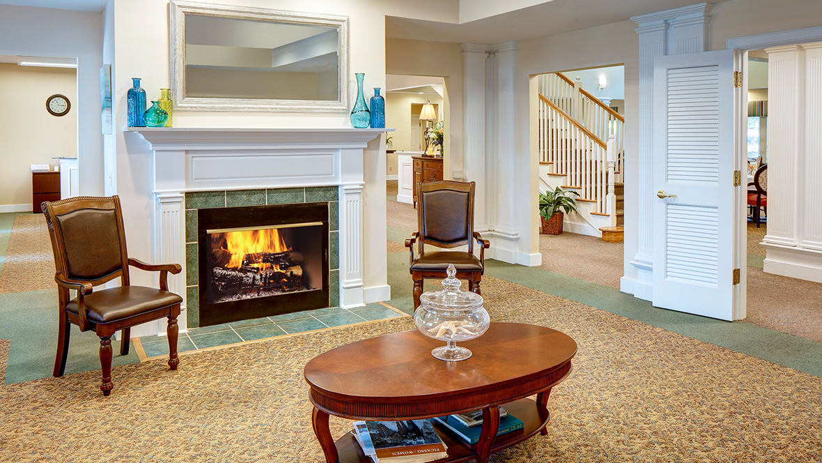 A cozy living room with a burning fireplace and elegant decor.