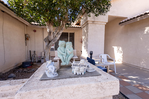 A serene outdoor setting featuring a couple sculpture and decorative elements.