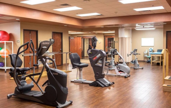 A well-equipped gym with various exercise machines and ample floor space.