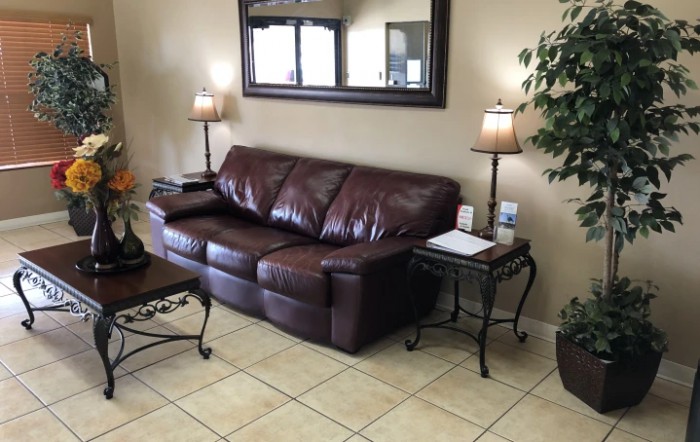 A cozy living room with a brown leather sofa and stylish decor.