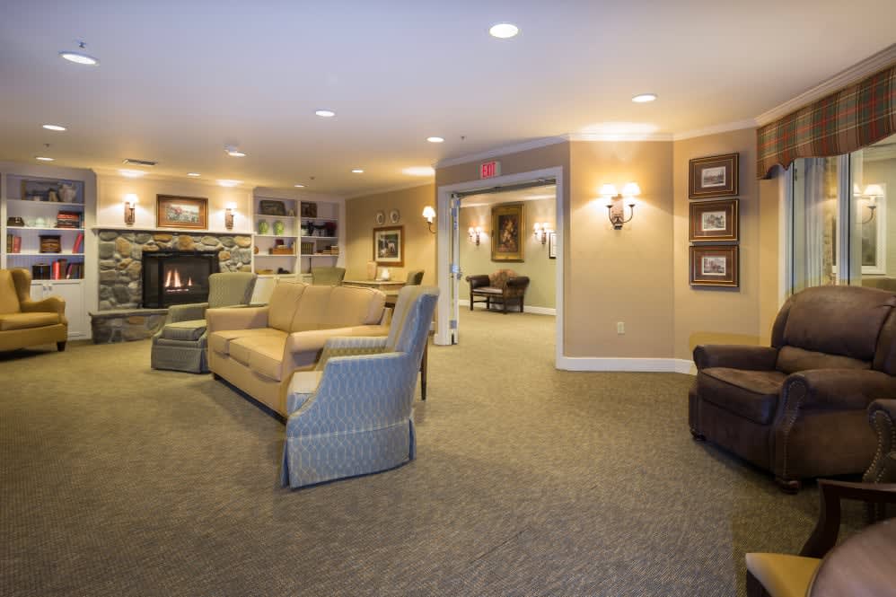 A cozy living room with a fireplace, sofas, and soft lighting.