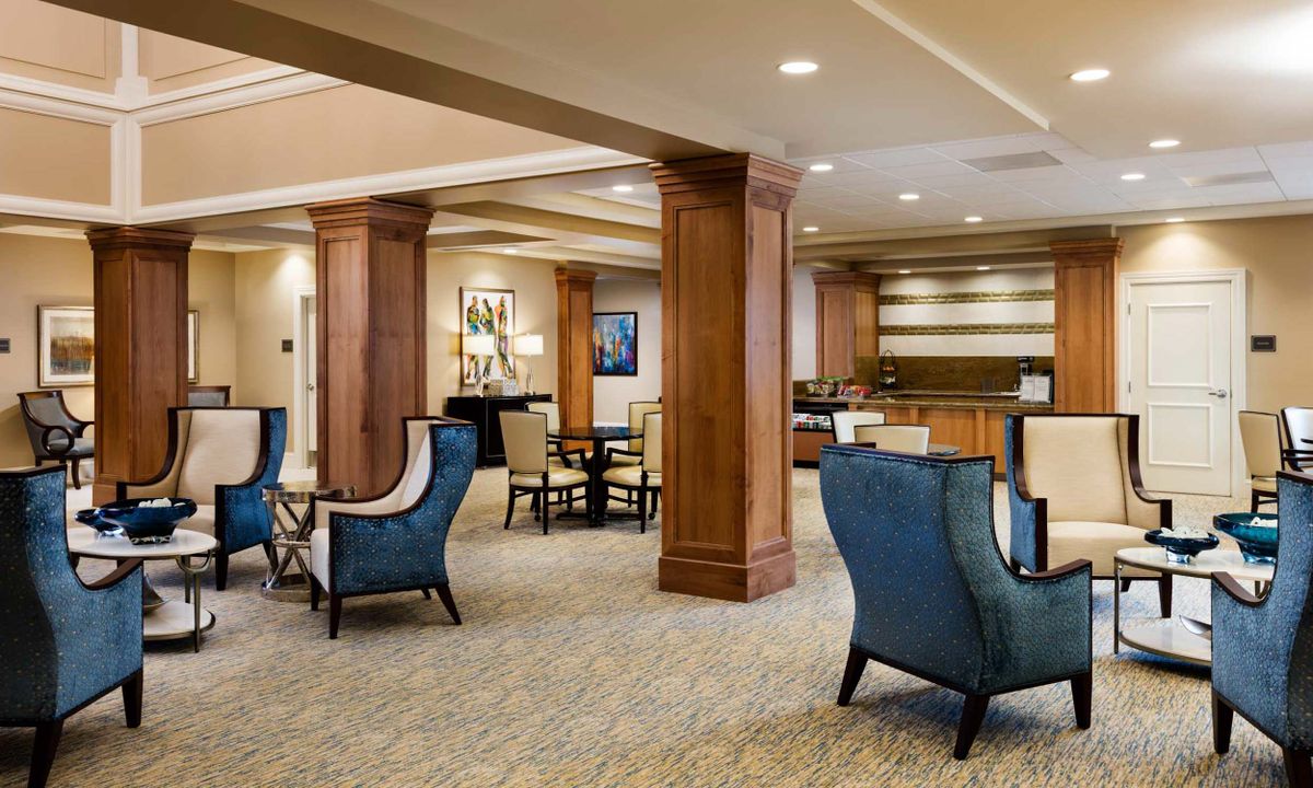 A spacious and elegantly designed hotel lobby with comfortable seating and wooden accents.