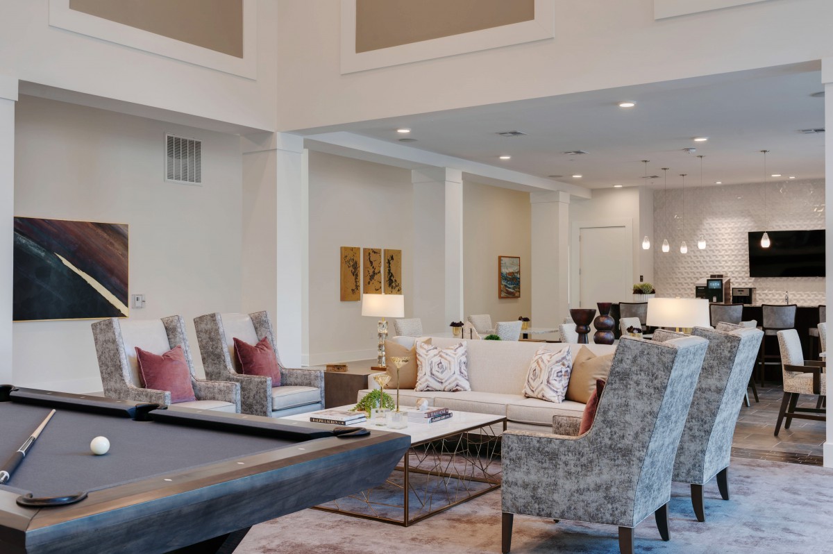 A spacious and elegantly designed living room featuring modern decor with neutral colors and comfortable seating.