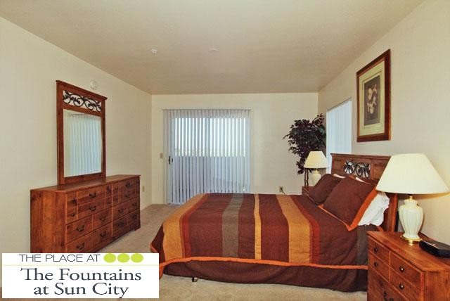 A well-furnished bedroom with a bed, dresser, and decorative elements.