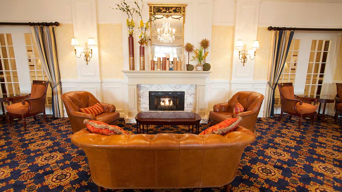 A cozy, luxurious living room with a fireplace and plush seating.