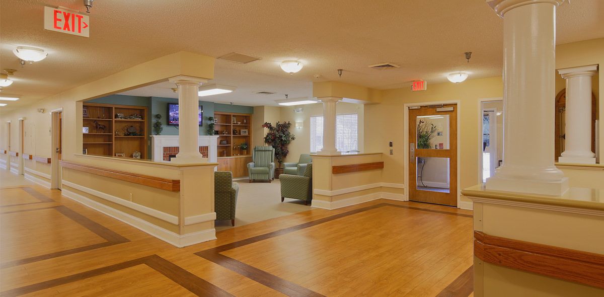 A cozy and welcoming nursing home lobby with comfortable seating.