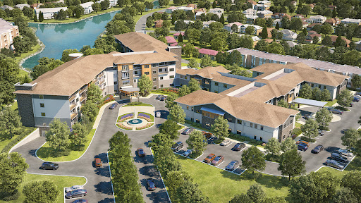 Aerial view of a modern community development featuring residential buildings and landscaped areas.