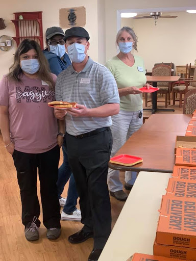 Volunteers gathering to prepare food for a community event.