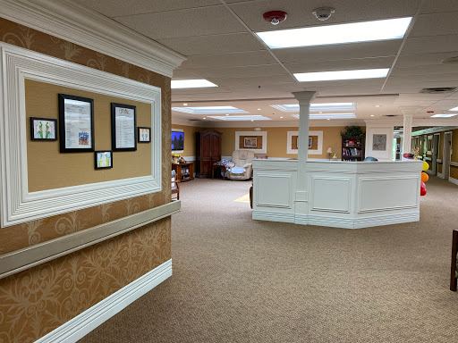 A spacious and well-lit office reception area, featuring framed documents on the walls and a welcoming ambiance.