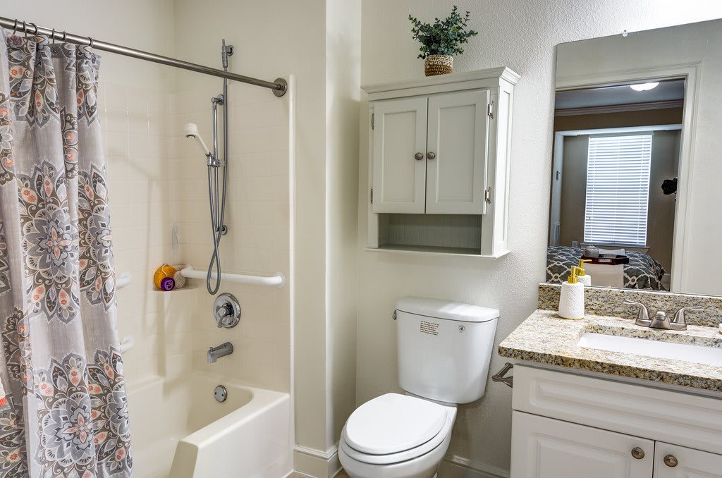 A well-organized bathroom with a bathtub, shower, toilet, and sink.