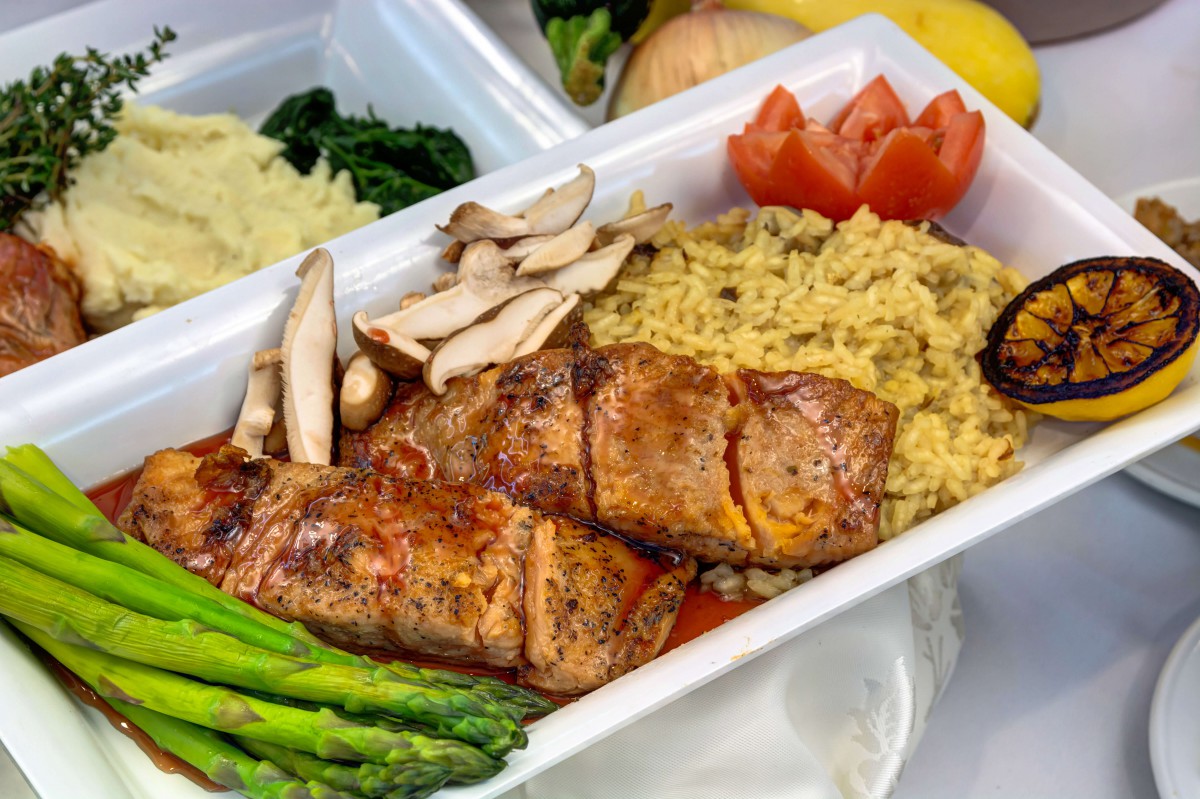 A healthy meal featuring grilled salmon, asparagus, mushrooms, and seasoned rice.