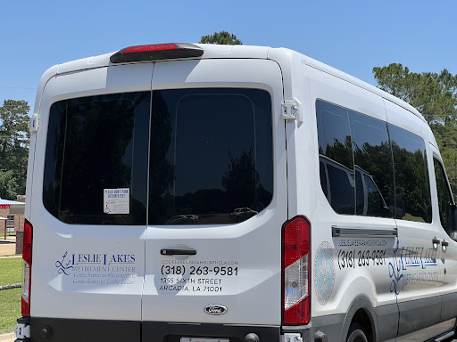 A white van parked, showcasing its rear and windows.