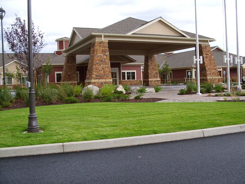 A modern building with a covered entrance and well-maintained landscaping.