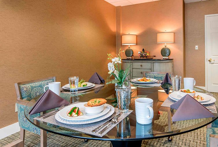 An elegantly set dining table with stylish decor and warm lighting.