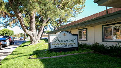 The entrance sign of Fairmont Senior Living, set against a backdrop of greenery.