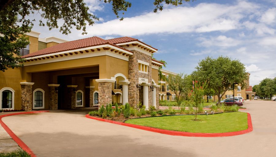 A welcoming entrance to a beautifully landscaped hotel or resort.