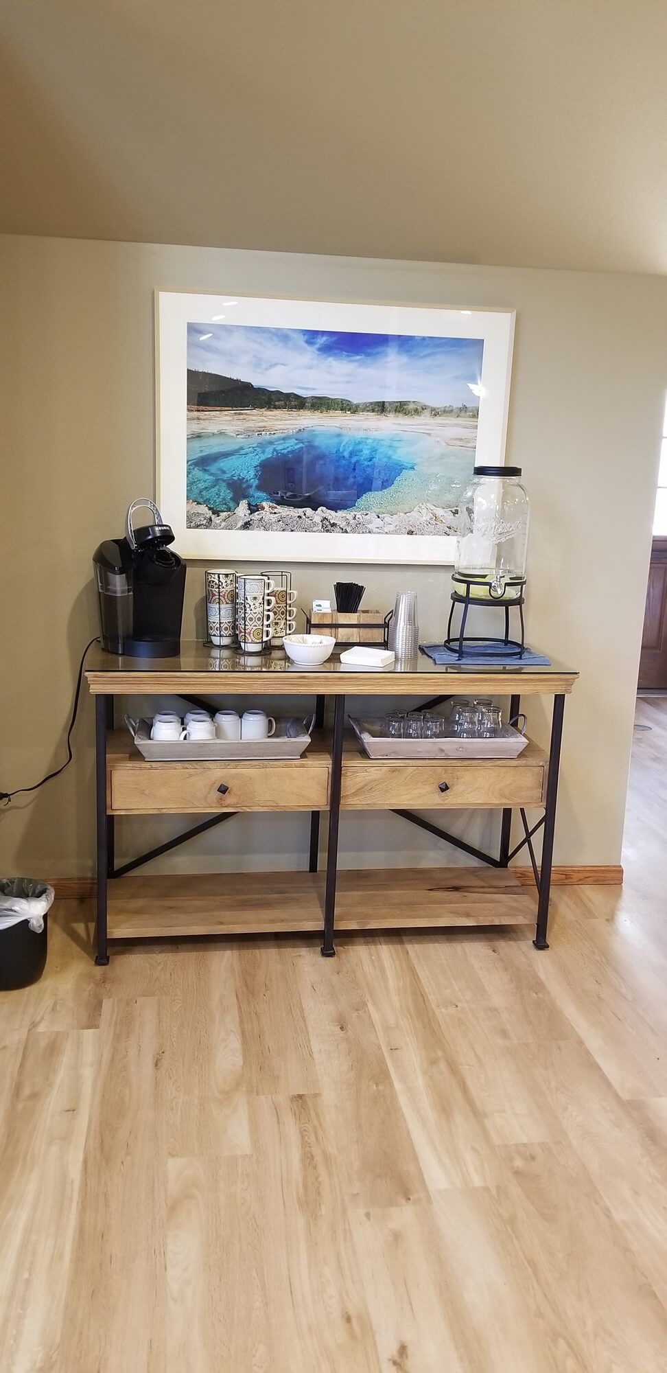 A well-organized coffee station with a wooden counter and various coffee essentials.