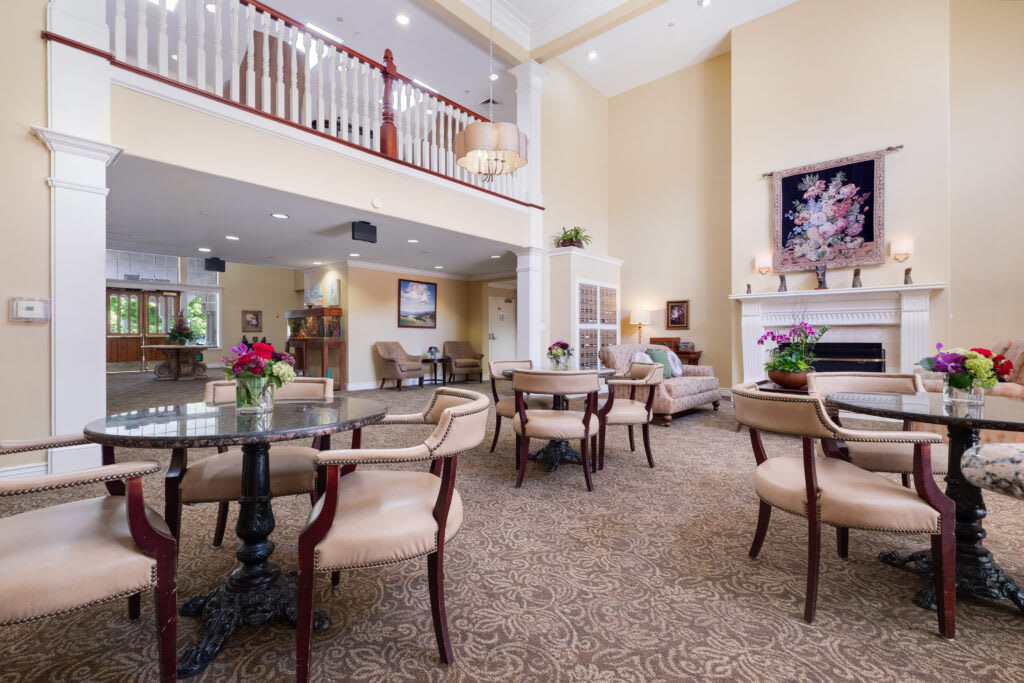 A spacious, elegantly designed living and dining area with modern furniture and bright lighting.
