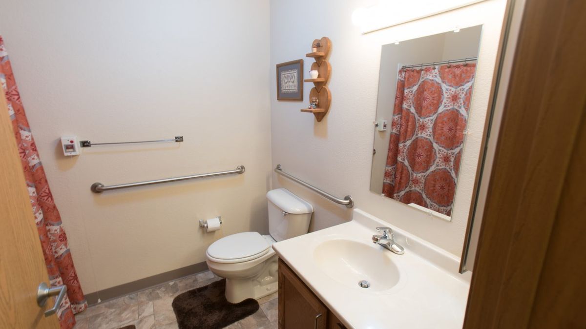 A clean and organized bathroom with a shower curtain and essential fixtures.