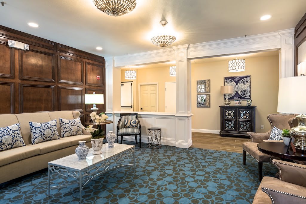 A well-decorated living room with elegant furnishings and a chandelier.