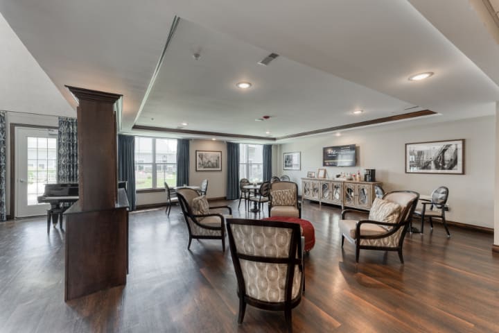 A spacious living room with elegant furniture and large windows.