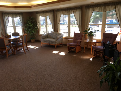A cozy living room space filled with natural light, featuring comfortable seating and a welcoming atmosphere.