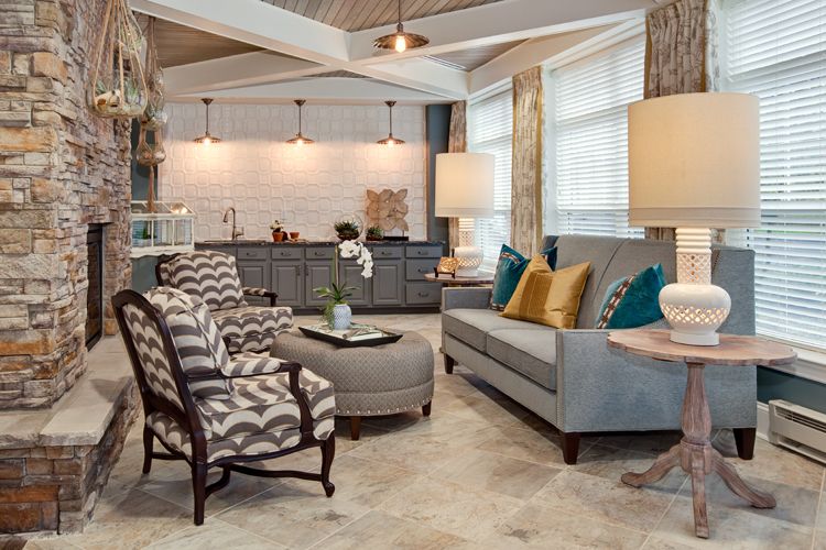 A stylish open-concept living room with modern furniture and a cozy kitchen area.