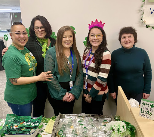 A joyful group celebrating St. Patrick's Day with festive attire and accessories.