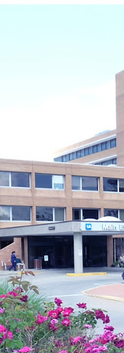 A view of a hospital building featuring multiple windows and modern architecture.
