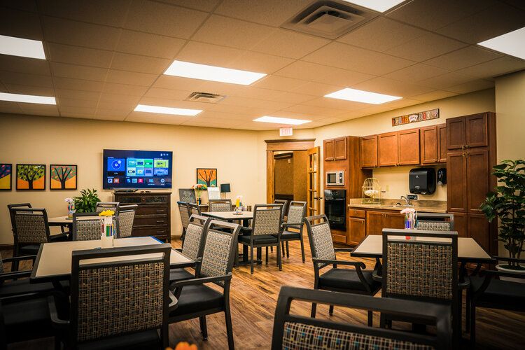 A cozy dining area with a modern kitchen and television setup.