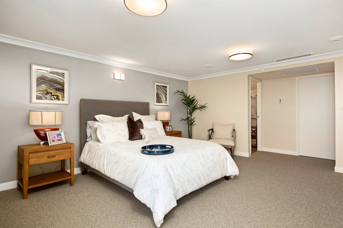 A cozy and modern bedroom interior with neutral tones and elegant decor.
