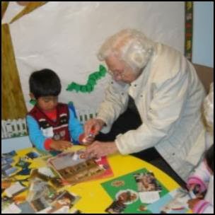 An elderly person engaging in an arts and crafts activity with a child, showcasing intergenerational interaction and creativity.