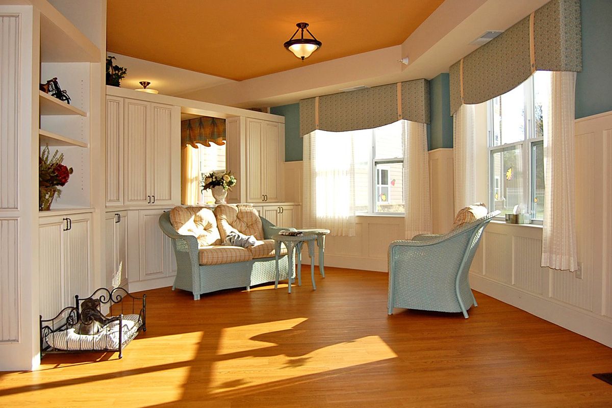 A sunlit living room with modern decor and comfortable seating.